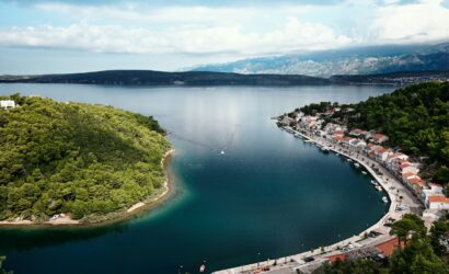 buildings near body of water and island