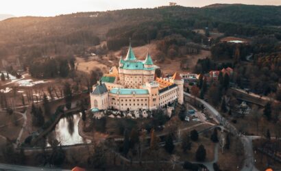white and brown concrete building near river during daytime