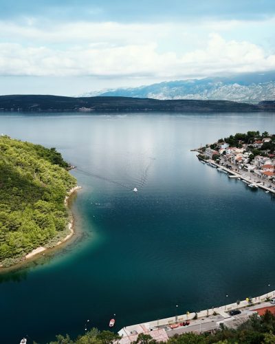 buildings near body of water and island