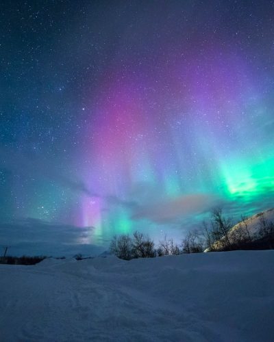 northern lights over snow-capped mountian