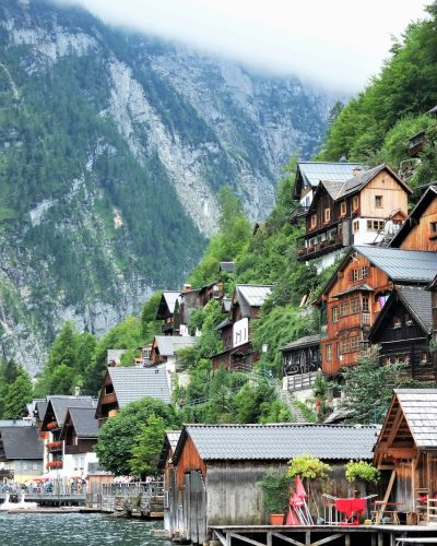 photography of buildings near mountain during daytime