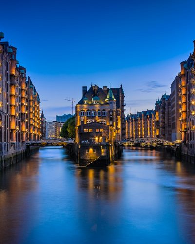 canal between buildings during nighttime